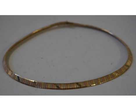An 18ct tri-coloured gold fancy link necklace, with engine turned and diagonal detail, stamped 750, approx 41.5gms.