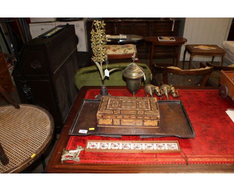 An oak desk stand; a mother of pearl inlaid trinket box AF; framed tiles; a wrought iron figure of a flower; a brass urn; two