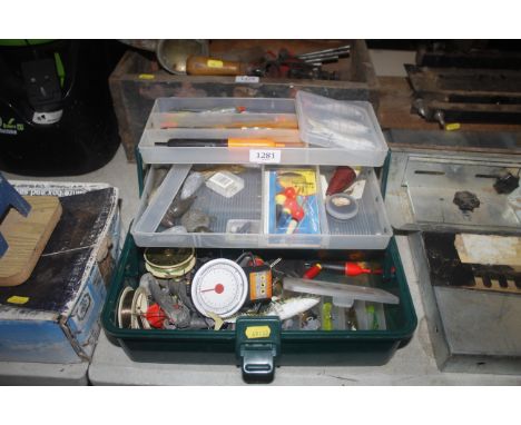 A fishing tackle box and contents to include lures; floats; various sea fishing leads etc.