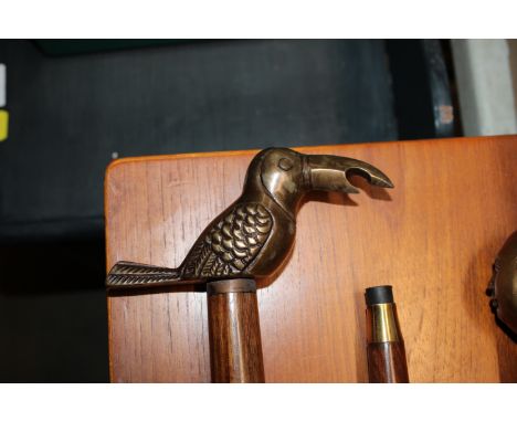 A walking stick, having bird bottle opener handle (59)