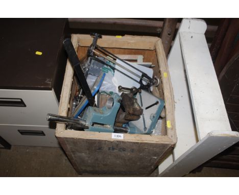 A crate containing a large quantity of tools to include a drill stand; a bench vice; silicon guns; fastenings and fixings etc