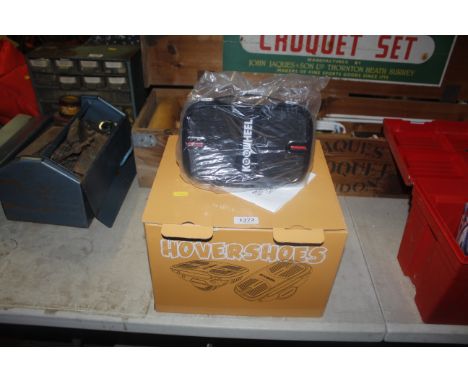A pair of Koowheel hovershoes with instruction manual