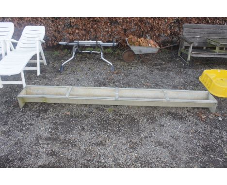 A galvanised metal feed trough