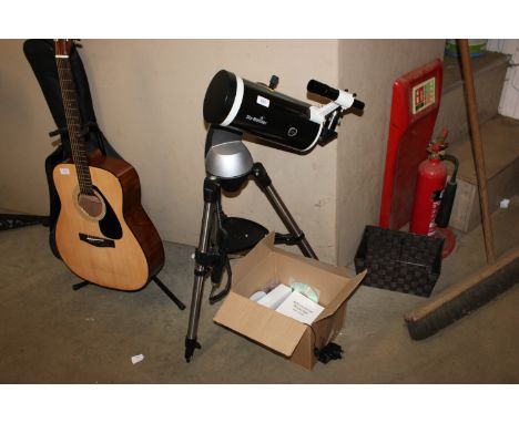A Sky watcher telescope on stand together with a box of various accessories
