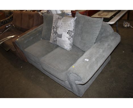 A green upholstered two seater sofa