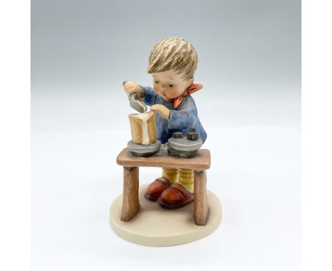 Hand painted figure of a young lad weighing flour. Goebel backstamp. Issued: 20th centuryDimensions: 3.75"L x 3.5"W x 5.75"HM