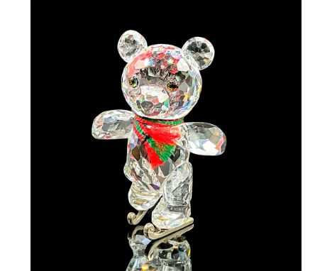Brilliant cut crystal figure of Kris Bear ice skating, wearing a green and red scarf. Item number 7637NR000002. Part of the W