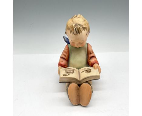 Boy reading a book colored in soft pallet of orange, green, blue and brown. Hummel impressed mark and Goebel backstamp. Issue