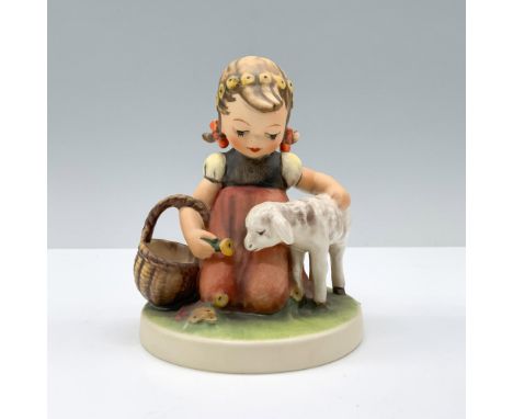 A young girl in a red apron and flower crown pets her sheep while holding a basket. Goebel Hummel backstamp. Dimensions: 4.5"