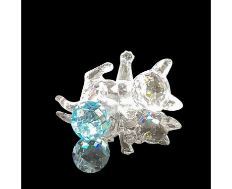 Adorable, faceted crystal figural with amber eyes, on his back reaching out to blue crystal ball. Swarovski backstamp. 7619 0
