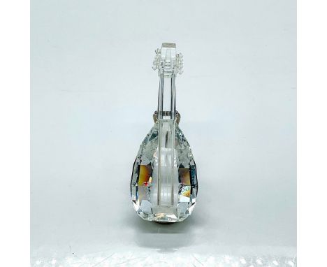 Multifaceted clear crystal lute with etched details on its face and a stand. Swarovski etched backstamp. This item has its or