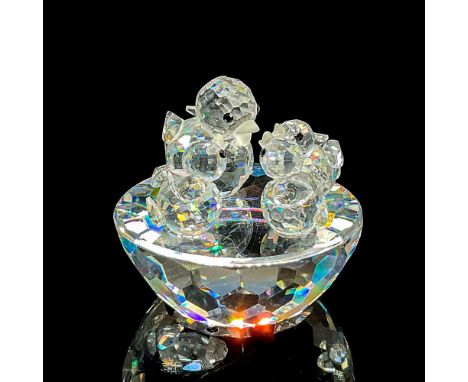 Sparkling clear cut crystal figure of a mother bird and three baby chicks in a nest. Swarovski etched mark. Item number 7470N