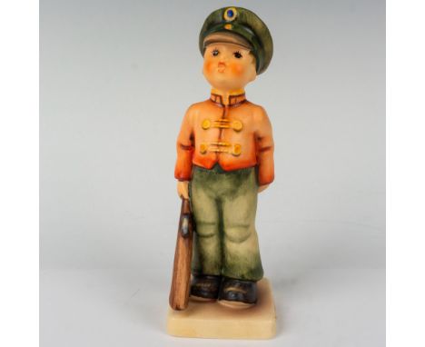 A charming hand painted in matte finish figure depicting a young German boy dressed as a soldier with toy rifle in hand. Goeb