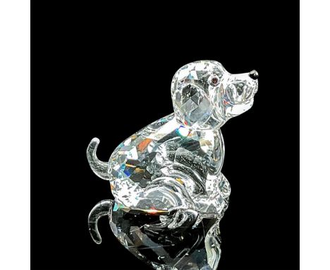 Clear faceted crystal figure of a seated dog looking upwards. Swarovski mark. Item number 7693NR000007. Part of the Chinese Z