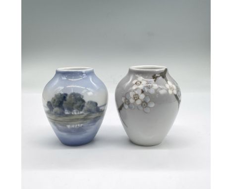 Two small porcelain vases. One with cherry blossoms on light grey background. The other features the reflection of trees in a