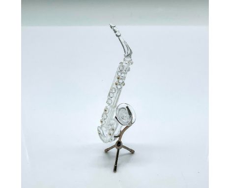 Multifaceted clear crystal saxophone with pearl dots. Part of the Crystal Melodies group and came with its own rhodium stand.