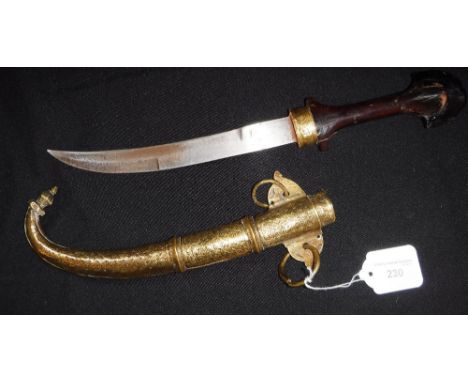 A NEPALESE OR INDO-PERSIAN KUKRI KNIFE in a decorated brass scabbard