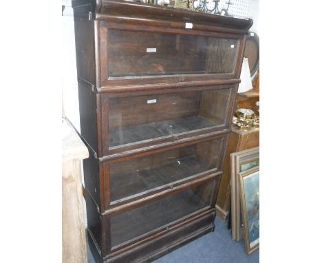 A FOUR SECTION GLOBE- WERNICKE OAK BOOKCASE, 34" wide