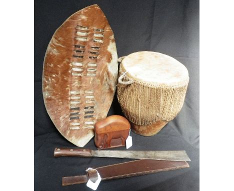 AN AFRICAN SKIN DRUM, early 20th century, a similar shield, a carved wooden cigarette box and an Indian machete 