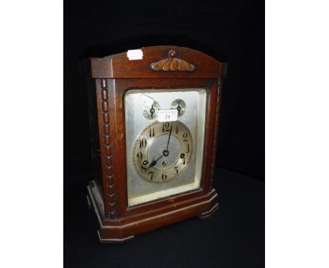 A 1920'S OAK CASED MANTEL CLOCK, with silvered dial and chiming movement