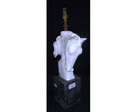 A TABLE LAMP IN WHITE ALABASTER, carved with a horse's head, on a grey marble block