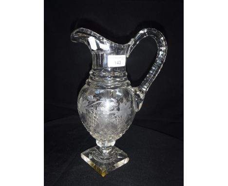 A REGENCY STYLE CUT-GLASS WATER JUG on 'Lemon Squeezer' foot