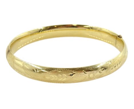 Gold hinged bangle with bright cut decorationCondition Report:Approx 9.65gm, stamped 14K but tested 12ct