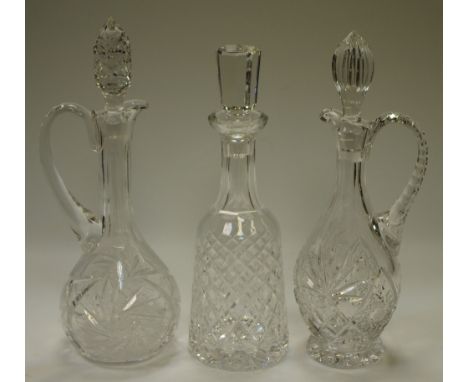 A Waterford cut glass mallet shaped decanter, faceted stopper; two other baluster decanters (3)