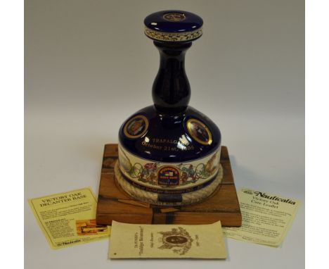 A Pusser's 'Battle of Trafalgar Bicentenary 1805-2005' ships decanter with a Victory oak decanter base made from oak salvaged