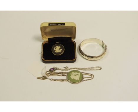 A Wedgewood Jasperware pendant, silver mounted with chain; a similar brooch, boxed; a hinged bangle chased engraving; stamped