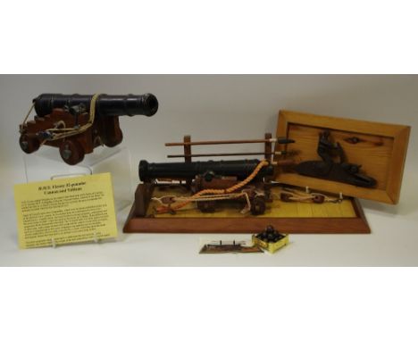 A HMS Victory 32 cannon and tableau by Nauticalia including gun tools,cannon balls and information leaflet approx 39cm long; 