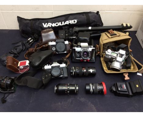 A mixed collection of cameras and camera equipment to include; a Canon Flex R2000 in case, a cased Fujica camera with spare l