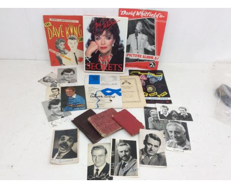 A collection of autographs to include Cary Grant, Dirk Bogarde, William Lucas and more along with a signed Joan Collins book 
