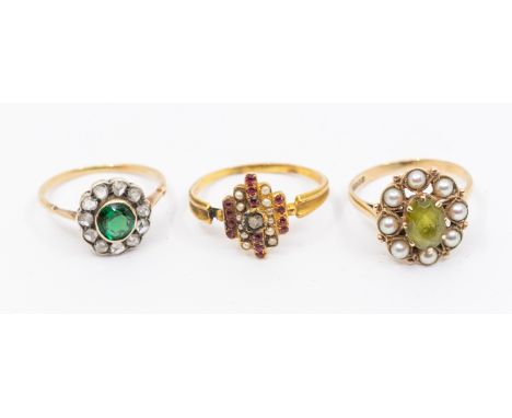 A collection of stone set gold rings to include a diamond and green garnet cluster ring set with a central round mixed cut ga