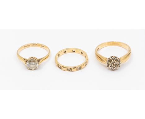 Three 9ct gold rings including diamond cluster ring, size P, a cubic zirconia set solitaire ring, size M1/2, and a stone set 