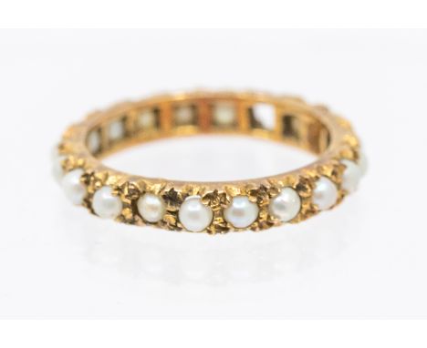 A pear set 9ct gold eternity ring, set with half pearls, width approx 3mm, size M1/2, (one pearl missing) total gross weight 