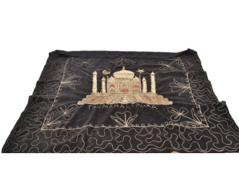 A black cloth depicting the Taj Mahal in rich gold bead encrusted embroidery stitched onto black velvet along with a mink tie