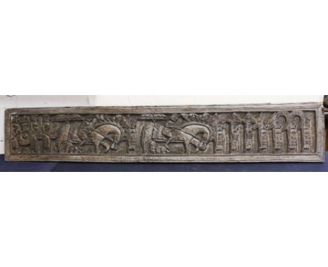 An Eastern oak carved wall panel, 196cm x 35cm with army marching carved detail, probably 19th Century.