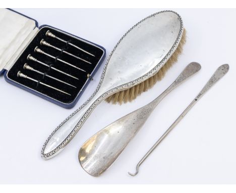 A small collection of silver items to include; a cased set of six novelty nail head silver cocktail sticks, hallmarked by Tho