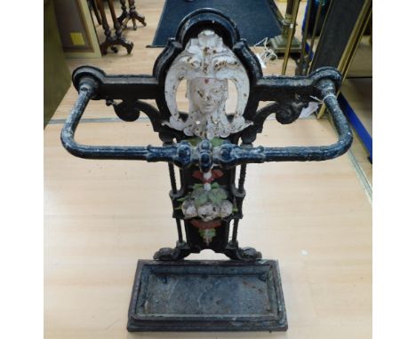 An antique Art Nouveau cast iron stick stand with central painted decorative design. Height 74cm, width 43cm.