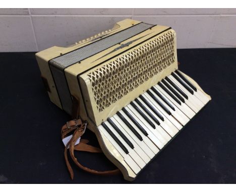 A 20th century Hohner faux mother of pearl cased accordian.