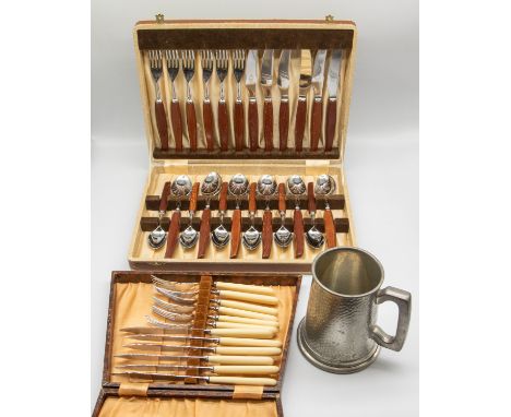 A mid 20th Century steel and wooden handled cased knife, fork and spoon set, marked Sheffield England, of stylish form, along