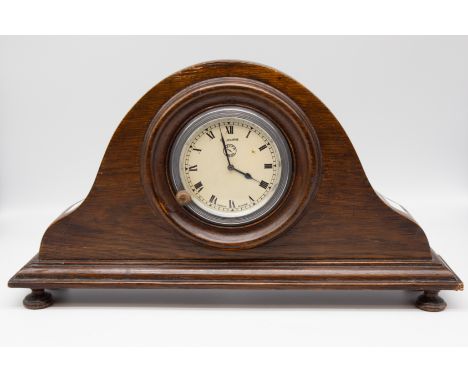 A mid 20th century Jaeger of Paris mantle clock, in oak with four feet and 8 Jours to dial.