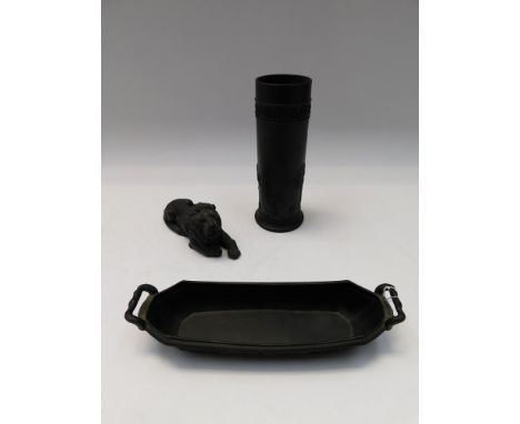 Three pieces of Wedgwood Black Basalt: a cylinder vase, a pen trough and a lion.&nbsp;
