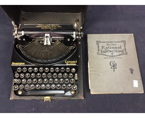 A cased black Remmington vintage typewriter along with a typewriter manual.