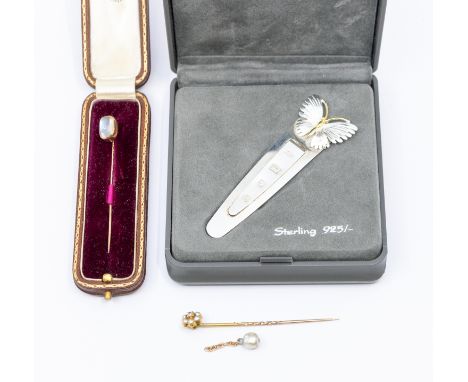 A moonstone and gold pin, set with an off oval moonstone, probably in 9ct gold, along with a diamond and pearl set stick pin,