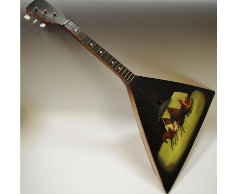 A Russian three-stringed balalaika, ebonised and hand painted with a horse drawn sledge bearing interior label with printed C