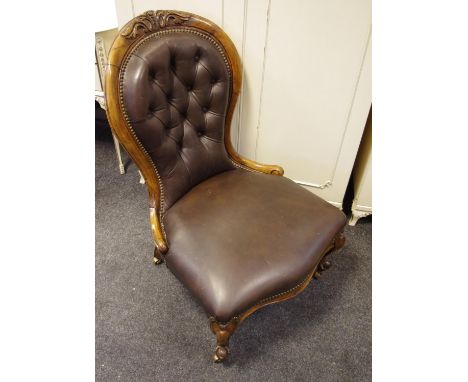 A Victorian spoon back nursing chair, button back, stuffed overseat, cabriole forelegs, brass casters.