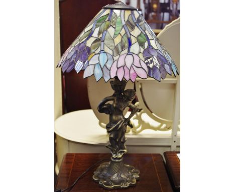 A Tiffany style lamp with bronzed classical Neo Classical caryatid column supporting a large floral lead lined smoky glass sh