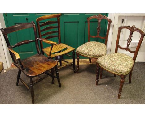 An early 20th century ash and elm carver chair; a ladder back rush seated kitchen chair; a pair of late Victorian dining chai